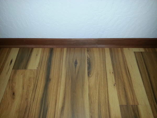 Quick Step Hickory Laminate flooring with Redwood 2" baseboard and 1/4 round redwood trim